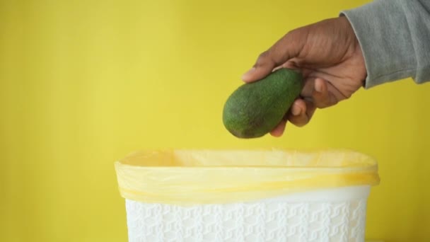 Throwing Avocado Garbage Bin — Stock Video