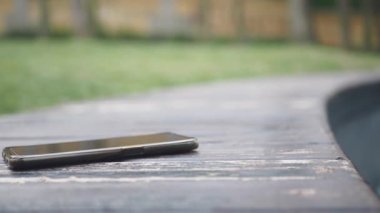 forget smartphone on a park bench, lost smart phone ,