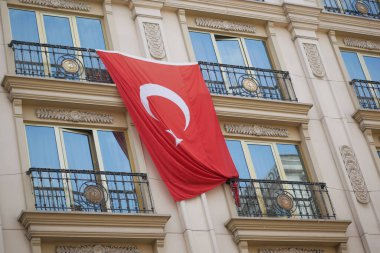 Pencerede Türk bayrağı asılı.