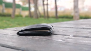  left wallet on a bench in the park ,
