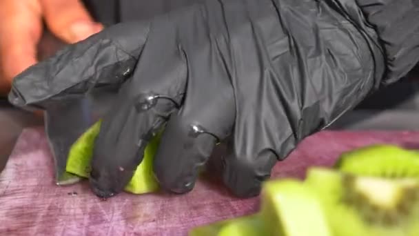 Hand Gloves Cutting Kiwi Fruits — Stock Video