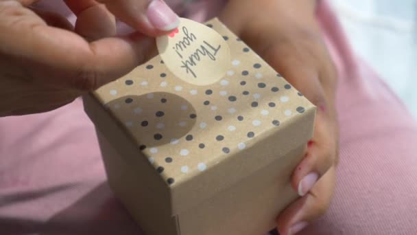 Hand Putting Thank You Stiker Gift Box — стоковое видео