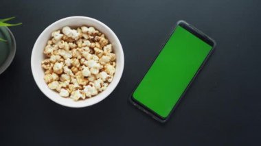 Akıllı telefon ve patlamış mısırın üst görünümü .