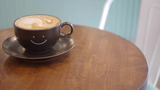 その上に笑顔の形のデザインのブラックコーヒーカップ — ストック動画