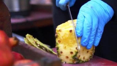 Eldiven takıp, ananası bıçakla doğradım. .