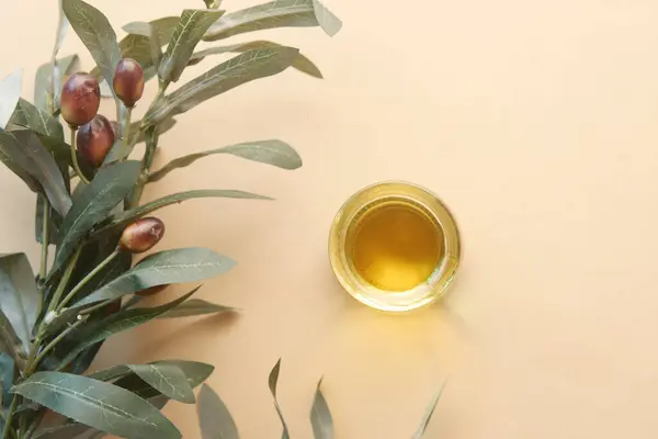 Flasche Olivenöl Und Olivenblätter Auf Gelb — Stockfoto