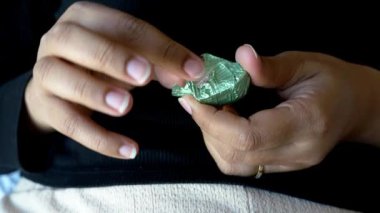 removing packet from a chocolate .