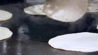  cooking roti chapati on a big cooking pan ,