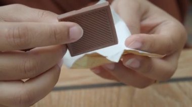 removing packet from a chocolate .