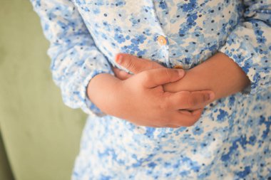  child suffering stomach pain close up..