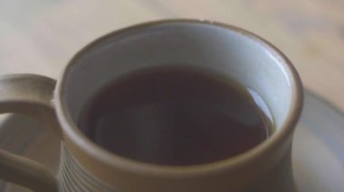 slow motion of pouring white sugar in a tea cup 