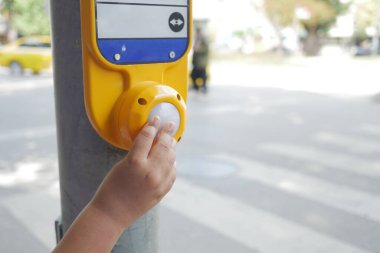 Yaya geçidi tuşuna basan bir çocuğun elini kapat , 
