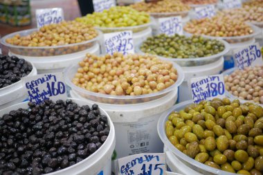 Buckets of olives for sale street food market.