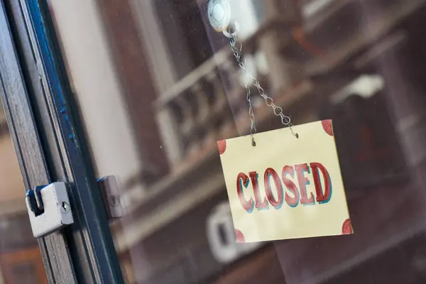 Cam kapıya asılmış kapalı tabela dükkan ya da iş yerinin işlevsel olmadığını gösteriyor..