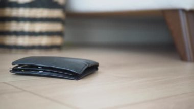  left wallet on floor at home .