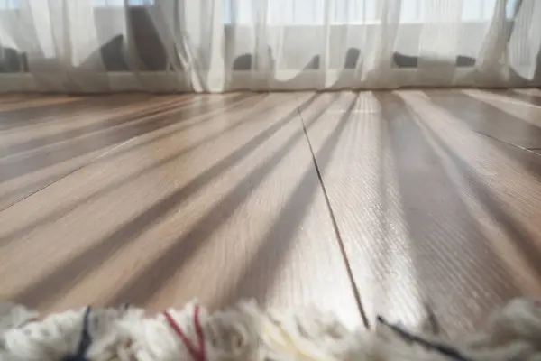 stock image The soft sunlight gently creates beautiful and captivating shadows on a lovely wooden floor