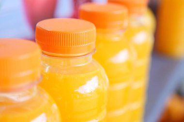 plastic bottle of orange juice in a shelf ,