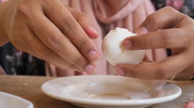women hand perfectly Peeled Boiled Eggs .