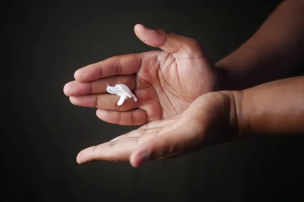 stock image Closeup of hands applying moisturizer cream. Ideal for skincare, beauty, and health media