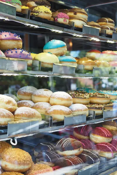 stock image A vibrant and colorful assortment of delicious and tempting donuts beautifully on display