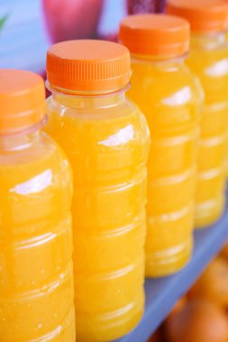 plastic bottle of orange juice in a shelf ,