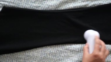 Cilalı bir görünüm için pamuk rulo kullanarak siyah taytlardaki iplikleri kolaylıkla temizler..