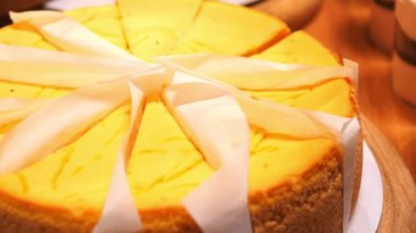 Nefis bir sunum için zarif bir kurdeleyle süslenmiş kremalı peynirli kek.