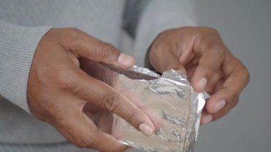 removing packet from a chocolate .