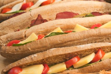 Enjoy our delicious sandwiches, filled with fresh, nutritious ingredients for your delight clipart