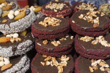 Çikolata ve fındıkla süslenmiş canlı ve renkli bir kurabiye gösterisi.