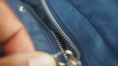 Man zipper on a jacket in cold autumn day. .