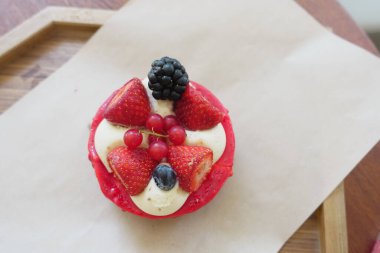 Closeup of a berry tart with fresh strawberries, red currants, blackberry, and blueberry clipart