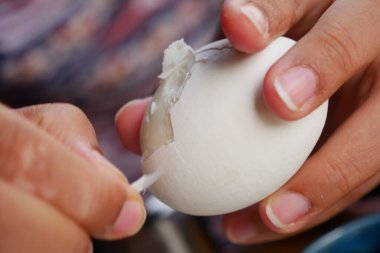 women hand perfectly Peeled Boiled Eggs .