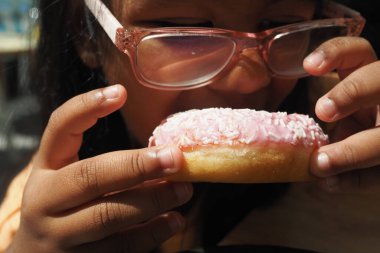  Çocuk ağzı çikolatalı donut yiyor. .