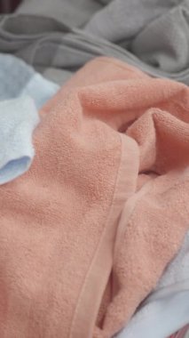 Yumuşak havluların titizlikle detaylandırılmış görüntüsü yumuşatıcı pastel gölgeler altında zarifçe bir araya getirilmiş.