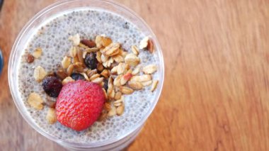 Üstü granola ve taze çilekle kaplı lezzetli chia tohumu pudingi, sağlıklı bir kahvaltı için mükemmel..