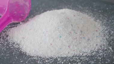 Büyük bir çamaşır deterjanı yığını. Rahatlık için pembe bir kepçe.