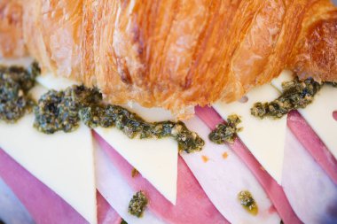 Lezzetli bir jambon, peynir ve pesto kruvasanı deneyin..