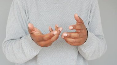 Avuç içleri açık bir şekilde ellerini kaldırır. Açıklık ve sorgulama hissi uyandırır..