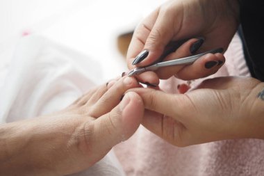 Yetenekli bir teknisyen müşteriye tırnak bakımı sağlar..