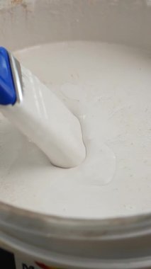 Evde sanatsal kullanım için beyaz boyayı karıştırma sürecini izle.