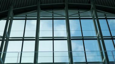 Sersemletici tasarım. Geniş cam pencereler var. Mavi gökyüzünü gösteriyor..