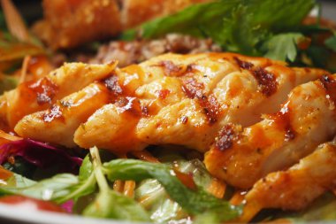 Lezzetli ızgara somon fileto ve yanında canlı sebze ve sebzeler..