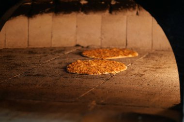 Taze ekmek, ahşap fırında pişer ve sıcak bir atmosfer yaratır..