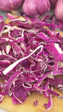 Kırmızı lahana dilimlemek ve sağlıklı bir yemek için sarımsak hazırlamak.