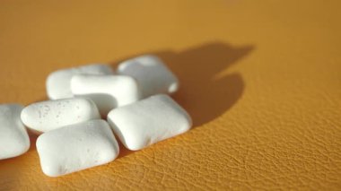 Parlak turuncu yüzey beyaz sakız parçalarının kontrastını artırır.