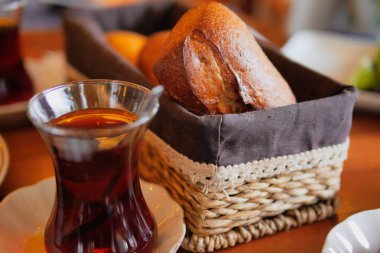 Sıcak çay, kırsal bir sepette taze pişmiş ekmekle eşleştirilir..
