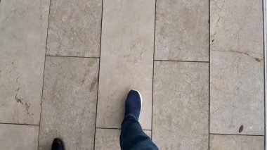 Şehirdeki taşların üzerinde yürüyen bireylerin ayak sesleri yankılanıyor..