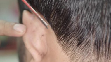 Bir berberin saçlarını ustalıkla kesişini izleyin..