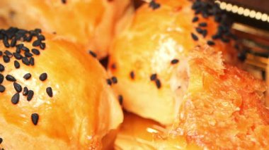 Susam tohumlarıyla süslenmiş lezzetli hamur işlerinin yakın çekiminin tadını çıkarın..